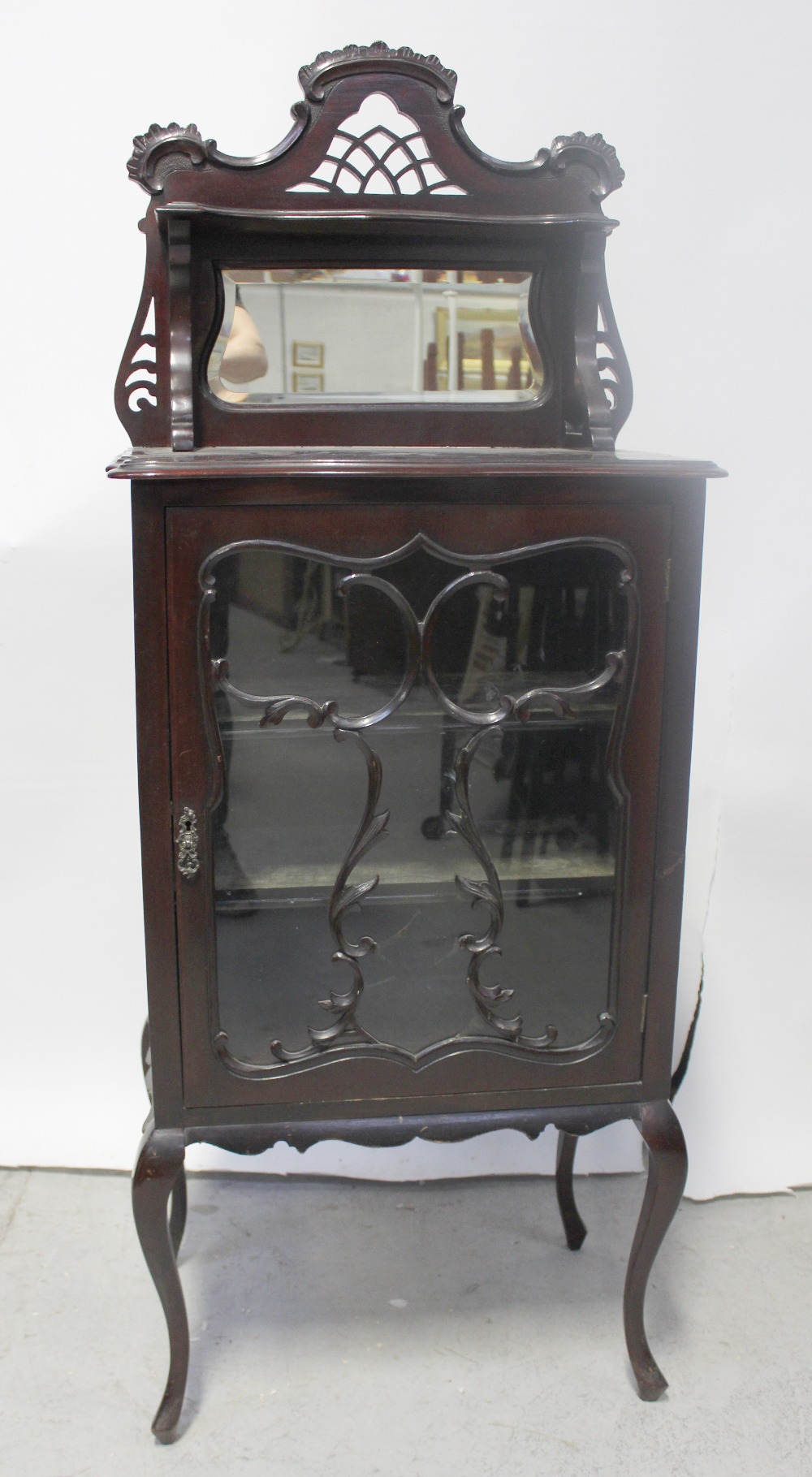 A 19th century mahogany mirror-back music cabinet,