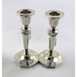 A pair of Edward VII hallmarked silver candle sticks, each with a single band of swags and foliate,
