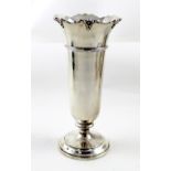A George V hallmarked silver trumpet vase with piecrust edge on a fitted base, Daniel & John Wellby,