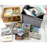 A large quantity of assorted postcards contained in three albums with a large assortment of loose