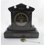 A Victorian slate mantel clock in the Classical style with pediment with gilt-heightened and