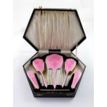 A George V hallmarked silver and pink guilloché enamel five-piece dressing table set,