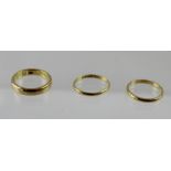 A gentlemen's 22ct gold wedding band size Q and two other 22ct gold wedding bands,