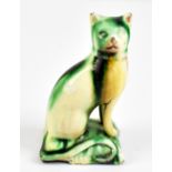 A late 18th/early 19th century Whieldon type figure of a seated cat modelled upon a cushion,