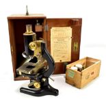 W.R. PRIOR & CO; a black lacquered microscope in mahogany case with assorted lenses and slides.