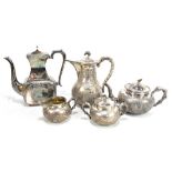 ZEE WO; a circa 1900 Chinese Export silver four piece tea service, all with repoussé decoration of