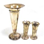A George V loaded silver vase, Birmingham 1921, height 20cm (af), and a small pair of loaded