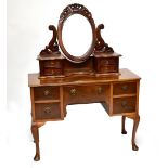 A mid-20th century burr walnut veneered knee hole dressing table, width 115cm.