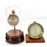 T.A REYNOLDS & CO OF LONDON; a brass cased circular barometer, diameter 11.5cm, together with a