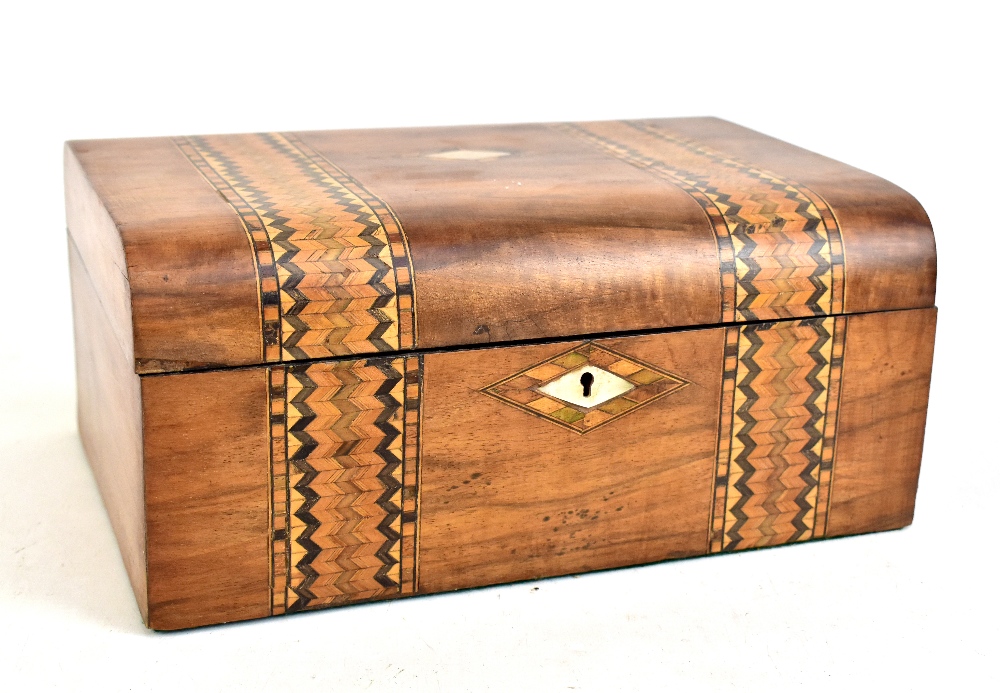 A 20th century walnut inlaid work box with mother of pearl cartouche.