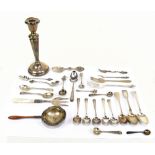 A group of small silver and white metal including teaspoons, coffee spoon, strainer with turned