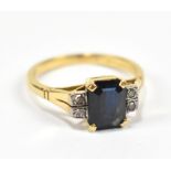 An 18ct yellow gold sapphire and diamond ring with central sapphire flanked by two pair of