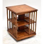 A reproduction yew wood revolving book case, height 64cm.Additional InformationAs this is a modern