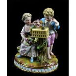 MEISSEN; a 19th century figure group of a young couple with garland of flowers beside a basket,