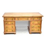 A Modern hardwood pedestal desk with stone panel inlay, six draws and one cupboard, width 165cm.
