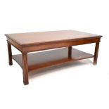 A reproduction mahogany rectangular coffee table with reeded supports and undertier, width 120cm.