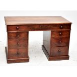 A 19th century mahogany twin pedestal desk with an arrangement of seven fixed and seven faux