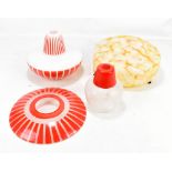 Two mid-20th century red, white and frosted glass light shades and a marbled Art Deco example,