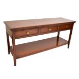 A reproduction mahogany side table with three frieze drawers and undertier shelf, length 150cm.