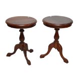 A pair of reproduction mahogany circular topped tripod tables, height 68cm (2).