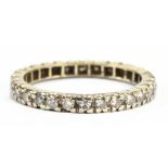 A white metal diamond full eternity ring, size O, approx 3g.