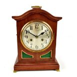 An early 20th century mahogany mantel clock, the circular silvered dial set with Arabic numerals and