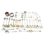 A group of hallmarked silver and white metal souvenir teaspoons including some with enamel detail,