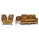 A good early 20th century stained beech double caned five piece bergere suite comprising settee,