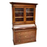 A 19th century mahogany cylinder bureau with fitted interior above three long drawers, with a
