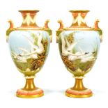 CHARLES BALDWYN FOR ROYAL WORCESTER; a pair of twin handled pedestal urn shaped vases painted with