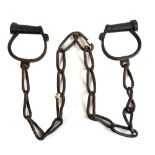 A pair of late 19th century iron handcuffs.