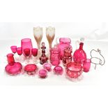 A quantity of cranberry glass including a jug, decanter, vases, etc, also a pair of opaque glass