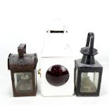Three railways lamps comprising a square petroleum example with L.M.S plaque, a white painted rear