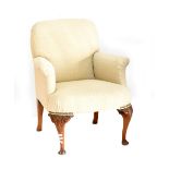 An early 20th century armchair, recently reupholstered, on carved cabriole legs.