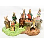 ROYAL DOULTON; The Bunnykins Robin Hood Collection comprising eight figures and base, all boxed.