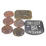 Seven cast metal railway plates comprising five L.M.S Wolverton 1925, 1927, 1930, 1934, 1939, an '