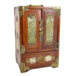 A hardwood brass detailed tabletop jewellery cabinet with twin doors enclosing four drawers with a