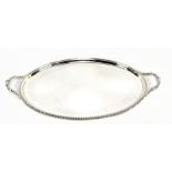 ROBERTS & BELK; an Elizabeth II hallmarked silver twin handled tea tray with scroll handles and