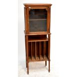 A mid-20th century French music cabinet with single glazed door above five vertical shelves,