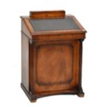 A reproduction mahogany Davenport with hinged sloping writing surface and four drawers to right