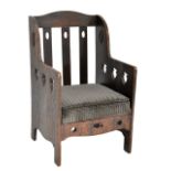 An Arts and Crafts carved oak armchair with splatted back and carved sides, retailed by Thomas