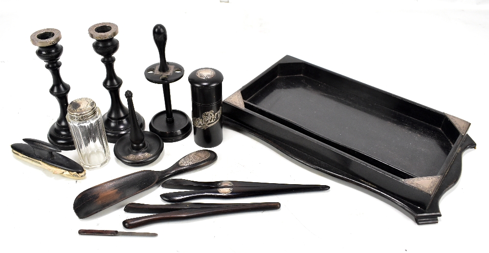 An ebony and silver mounted George V dressing table set comprising tray, pair of candlesticks, hat