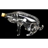 A late 19th/early 20th century novelty clear glass decanter in the form of a boar with associated