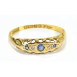 An 18ct yellow gold ring, set with sapphire and diamonds, size N/O, approx 2g.