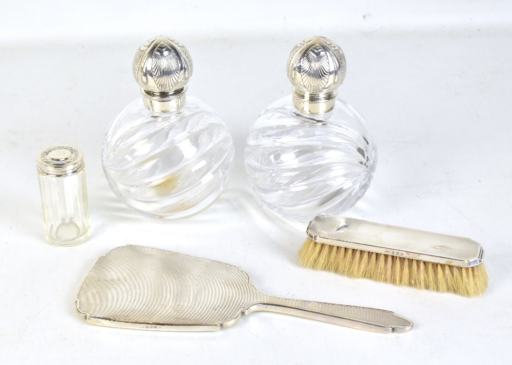 JOHN GRINSELL; a pair of Victorian cut glass perfume bottles with hallmarked silver stoppers,
