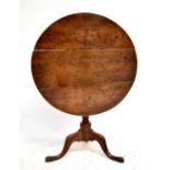 A George III oak circular tilt top table, diameter 78cm.