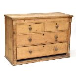A pine chest of two short over two long drawers, flanked by turned columns, 95.5 x 135cm (for