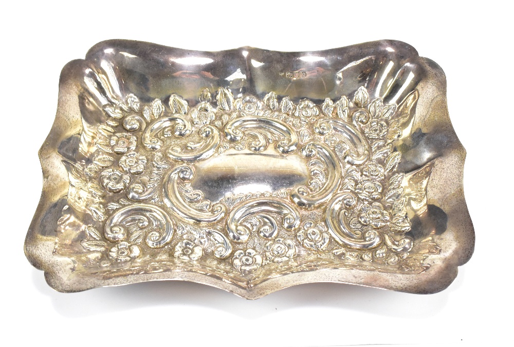 A late Victorian hallmarked silver floral embossed tray of shaped rectangular form, Chester 1899,