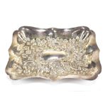 A late Victorian hallmarked silver floral embossed tray of shaped rectangular form, Chester 1899,