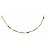 A 9ct yellow gold diamond, emerald and ruby sapphire line bracelet, length 20cm, approx 9.9g.